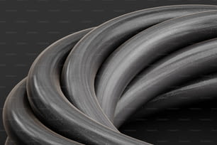 a group of gray hoses on a black background