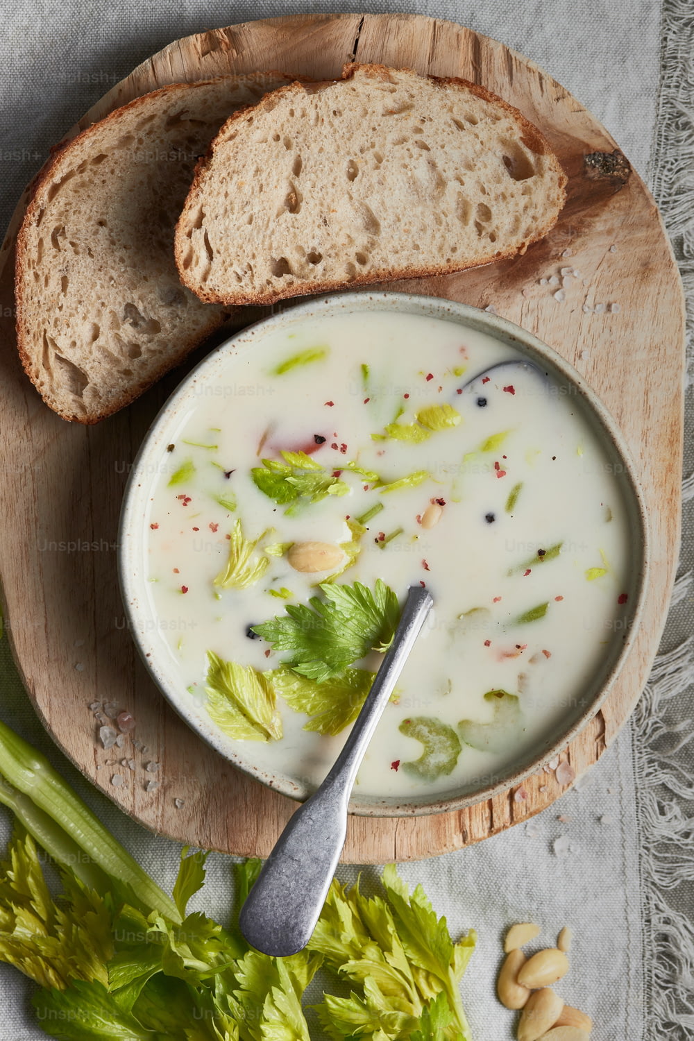 a bowl of soup with bread and lettuce