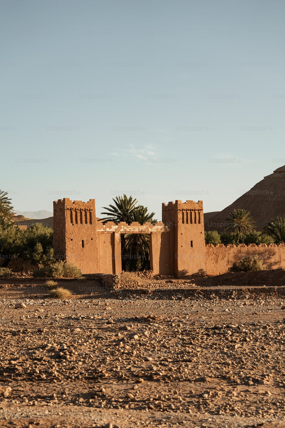 an adobe building in the middle of a desert