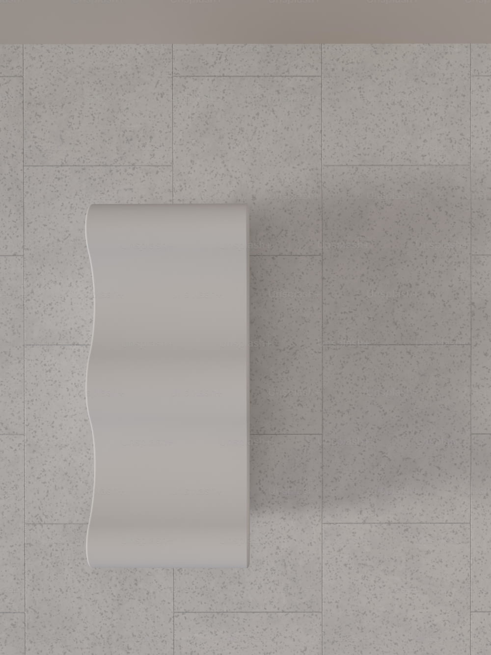 an overhead view of a white wall mounted urinal