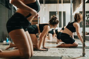 a group of women doing yoga in a gym