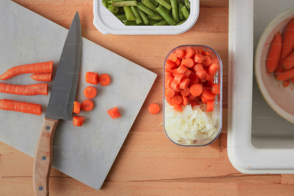 a cutting board with carrots, celery and onions