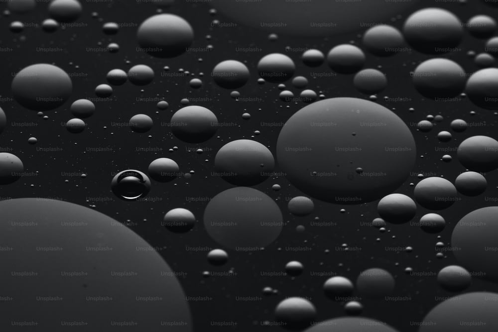 a lot of water droplets on a black surface