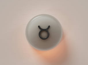 a white cup with a black ring on top of it