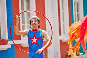 a man in a costume is holding a hoop