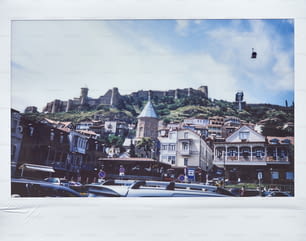 a picture of a city with a castle in the background