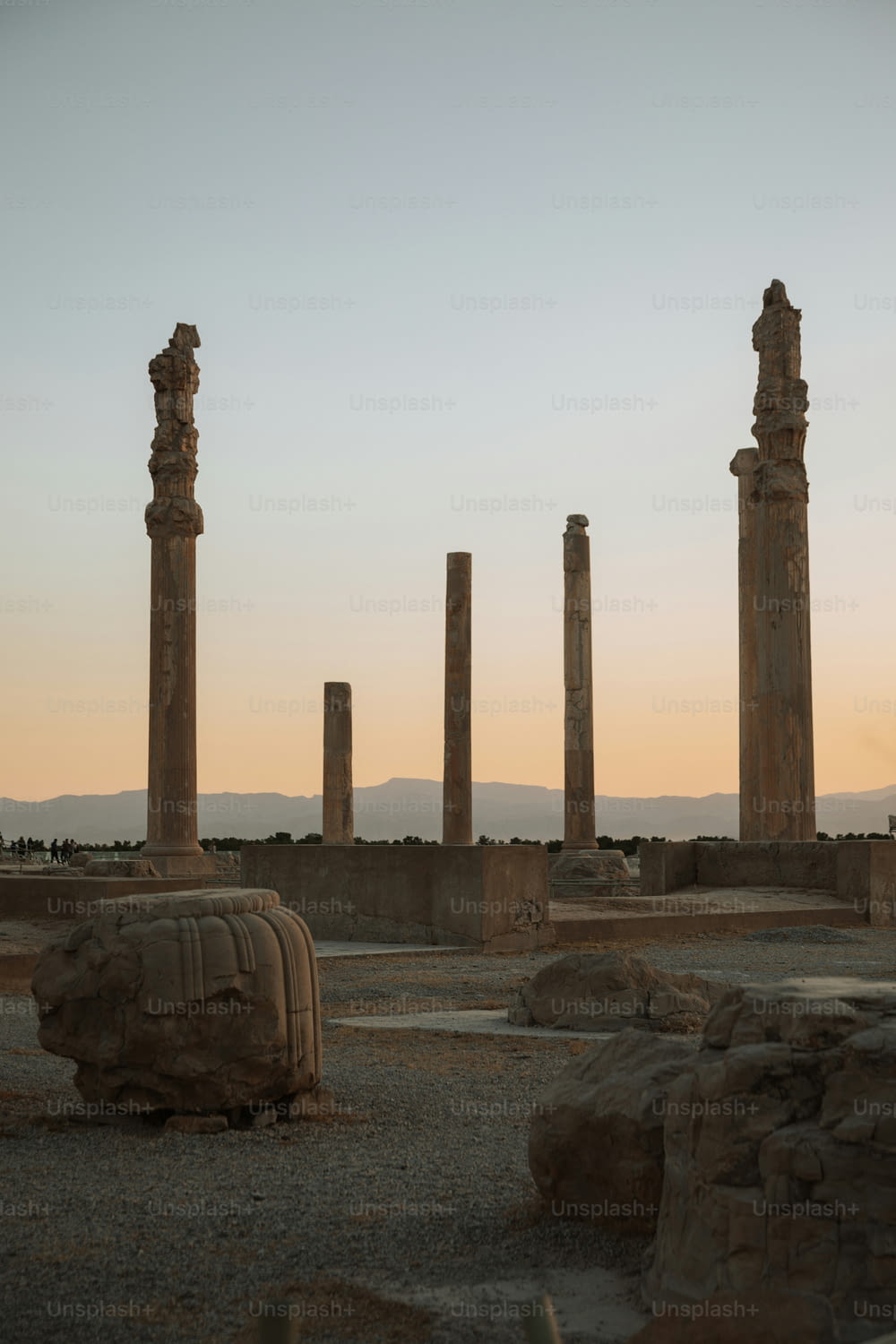 a group of stone pillars sitting in the middle of a desert