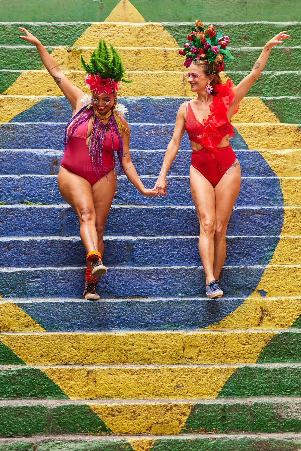 two women in bathing suits walking down a set of stairs