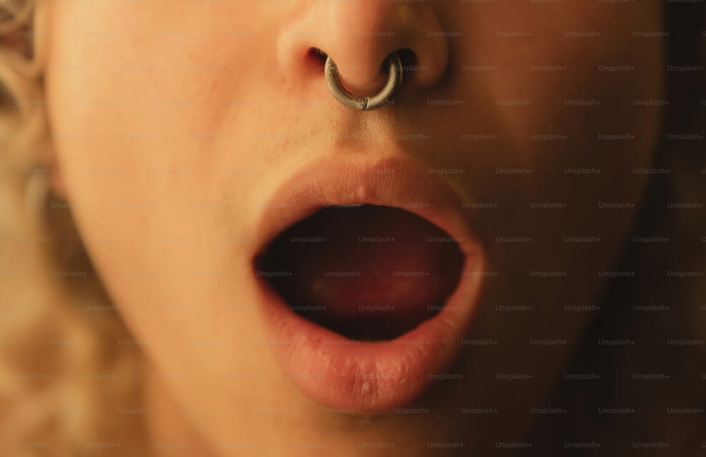 a close up of a person with a nose ring