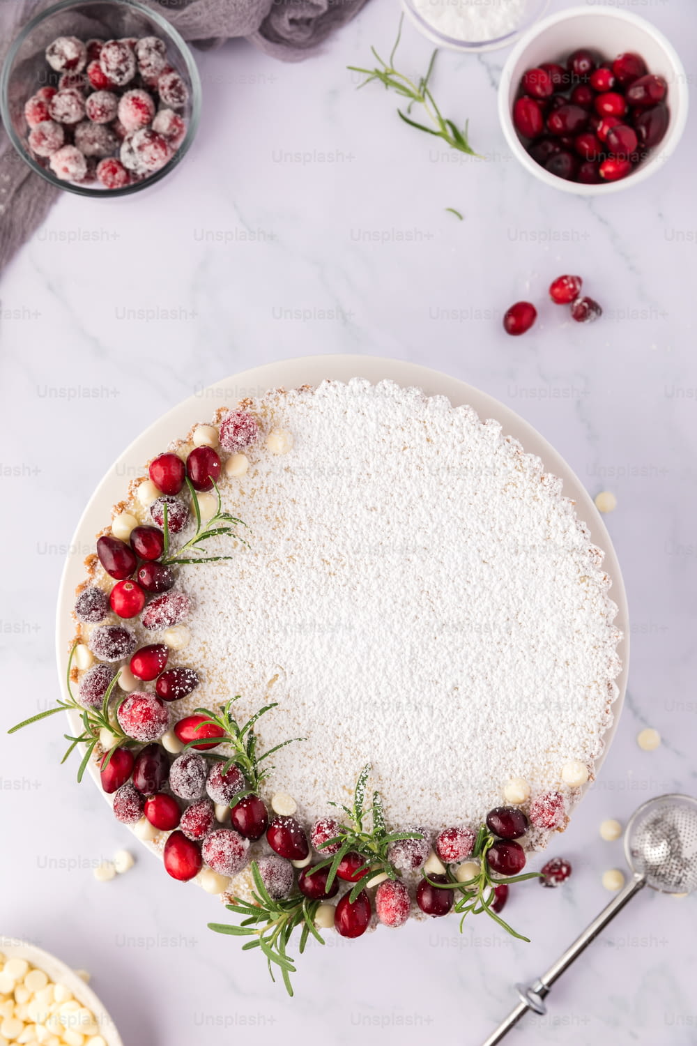 a white plate topped with a cake covered in cranberries