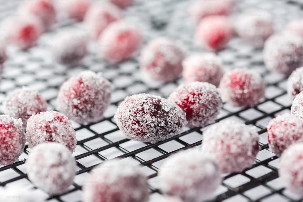 a bunch of powdered sugar balls sitting on a cooling rack