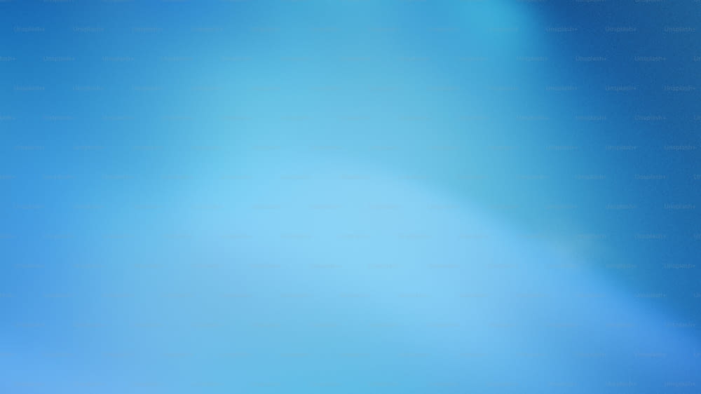 a blurry image of a blue sky with a plane in the distance