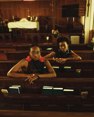 two women sitting in pews in a church