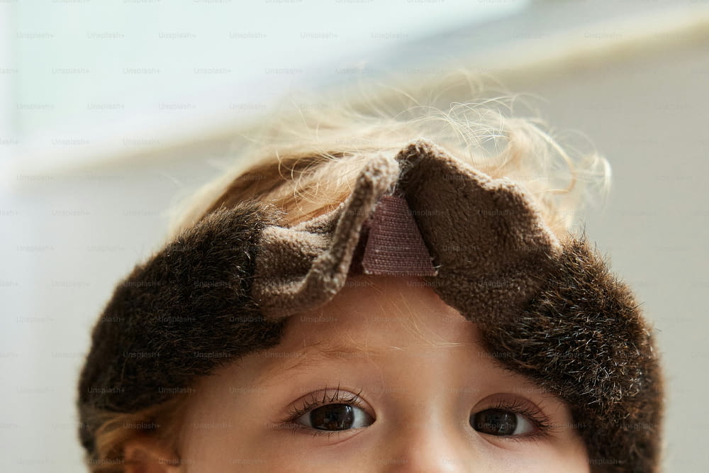 a little girl with a hat on her head