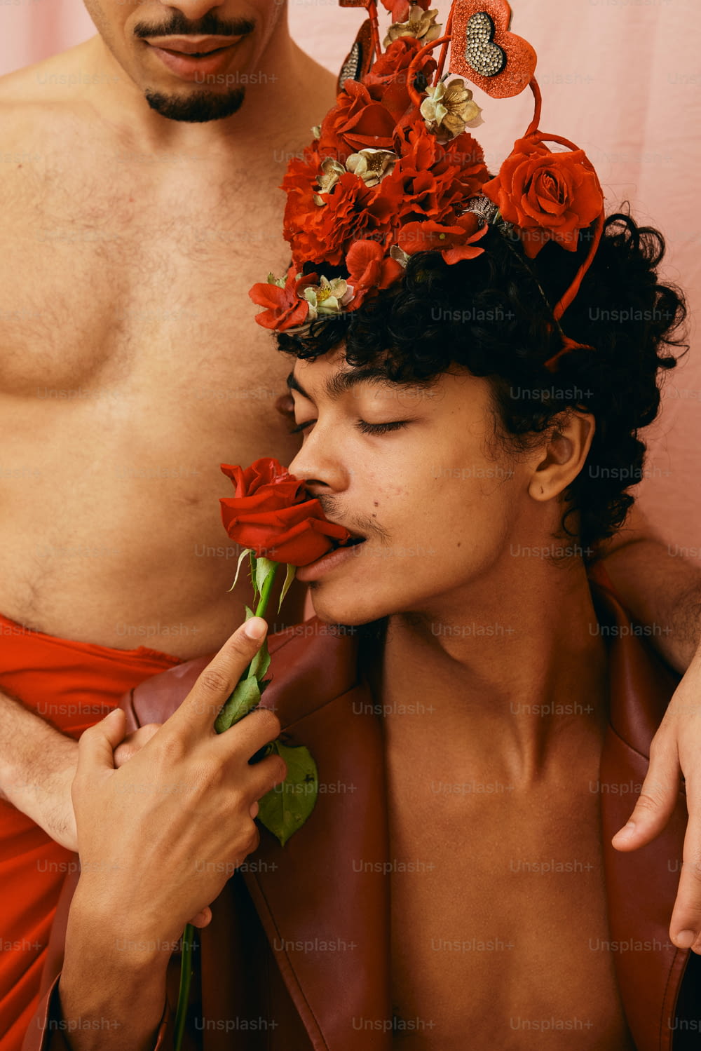 a shirtless man with a flower crown on his head