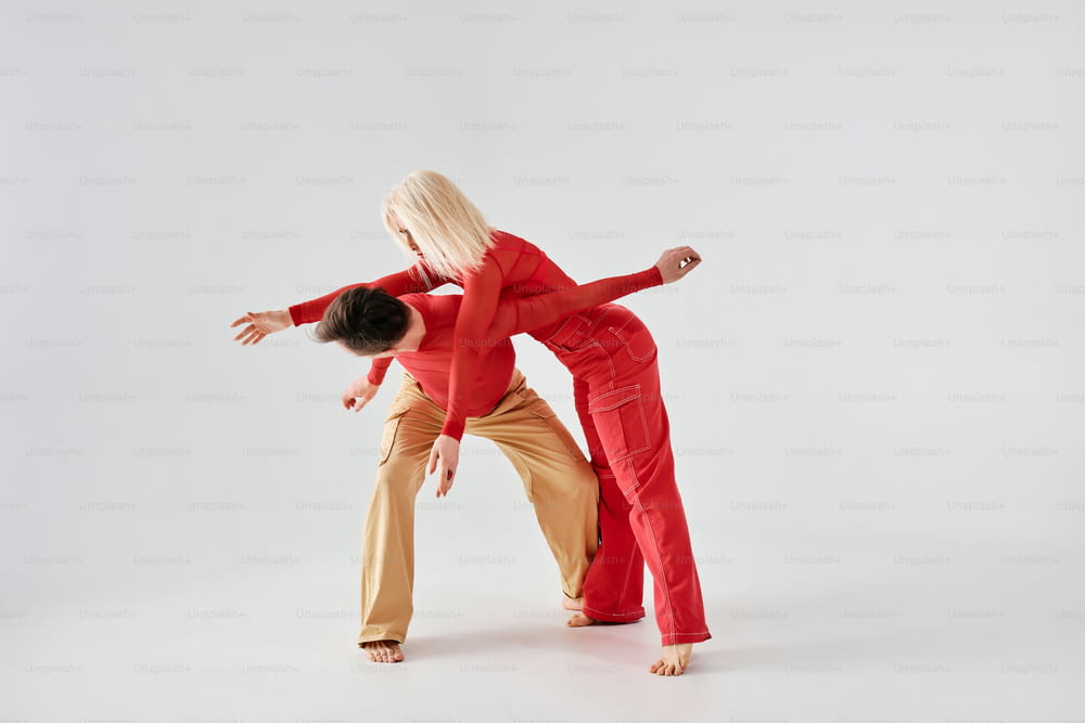 two people are doing a dance move on a white background
