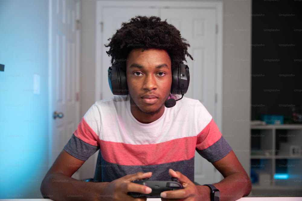 a young man wearing headphones and holding a video game controller