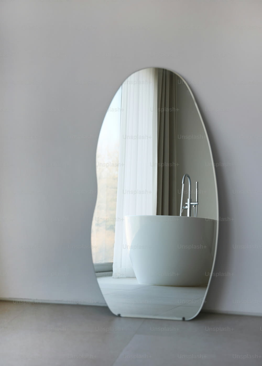 a white bath tub sitting under a large mirror