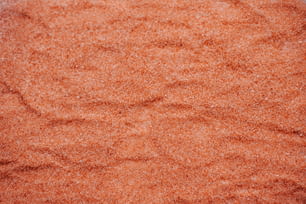 a close up of a red sand surface