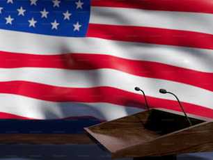 a podium with a microphone in front of an american flag
