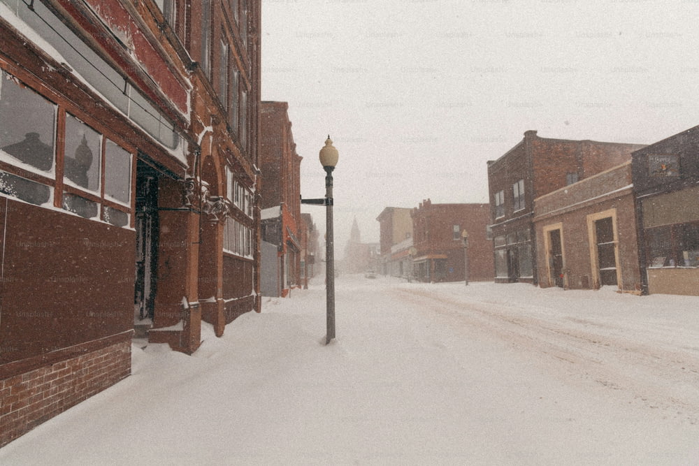 Eine Straßenlaterne auf einer verschneiten Straße in einer Kleinstadt
