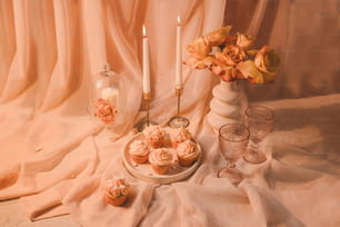 a table topped with cupcakes and a vase filled with flowers