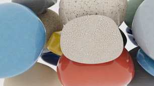 a group of different colored objects on a white surface