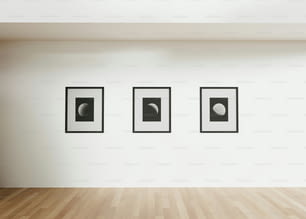 a room with three black and white pictures on the wall