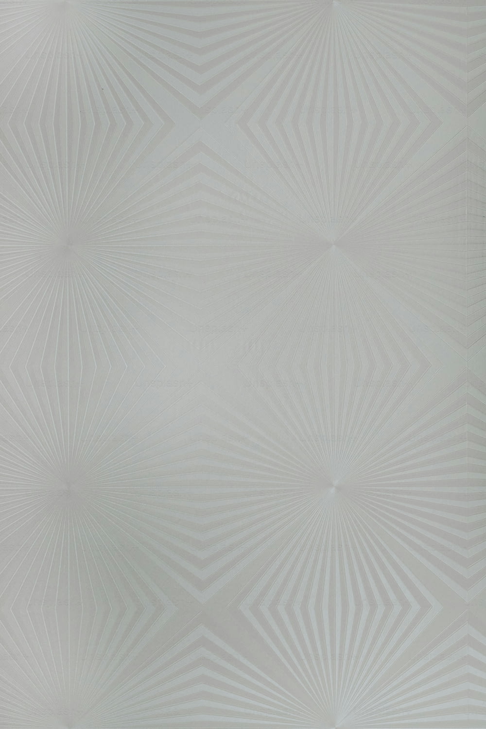 a white wall with a pattern on it