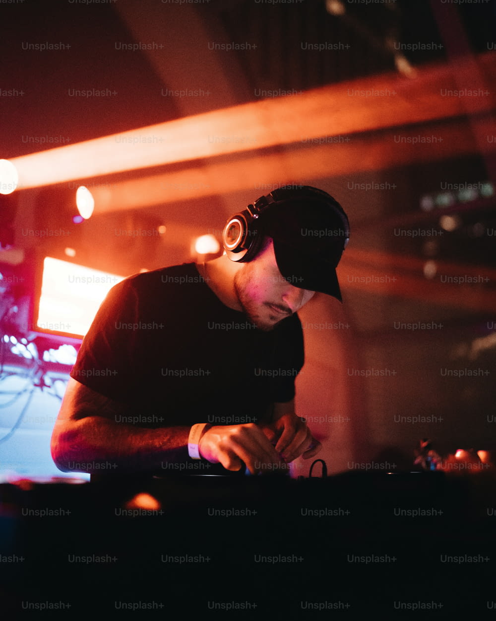 a man in a black hat is playing a dj's turntable
