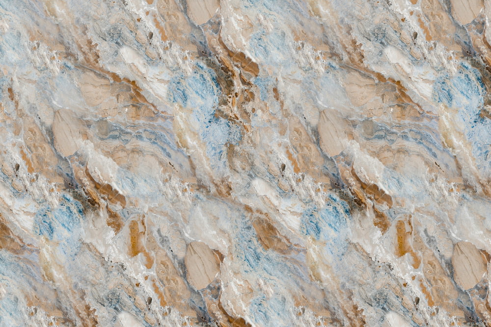 a close up of a marbled surface with brown, blue, and white colors
