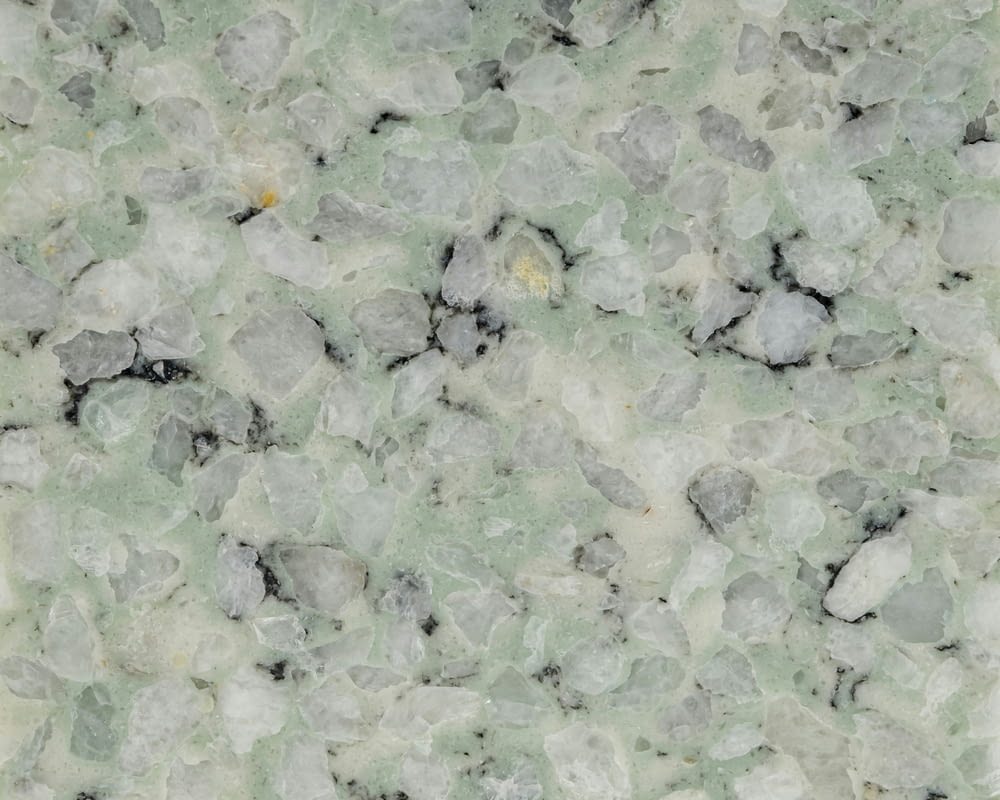 a close up of a marble surface with small rocks