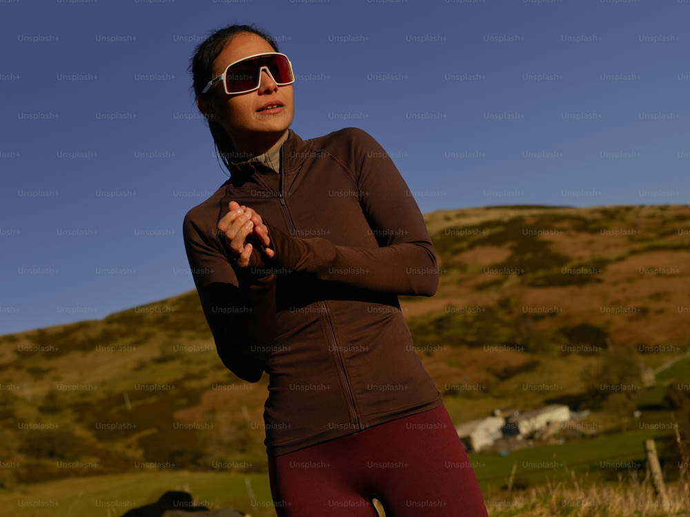 a woman in a brown top and red leggings