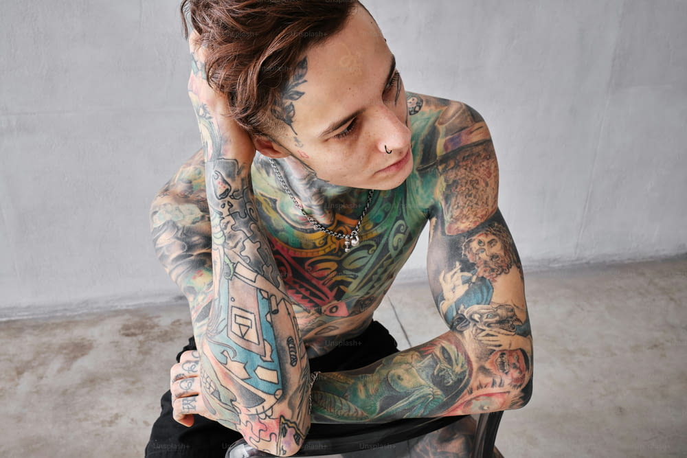 a man with a lot of tattoos on his body