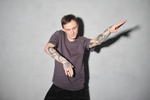 a man with tattoos on his arms and arms
