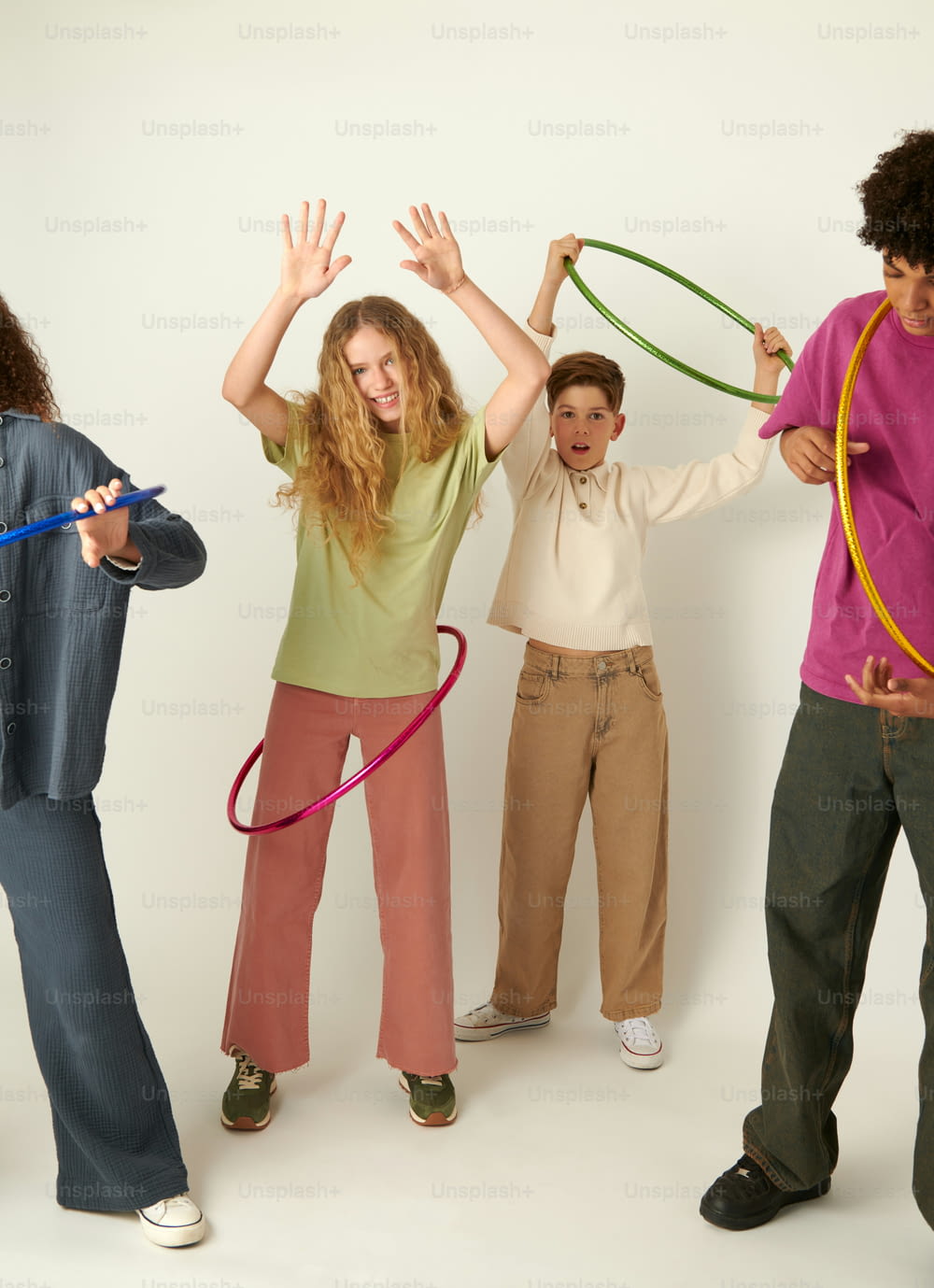 a group of young people standing next to each other holding hula hoops