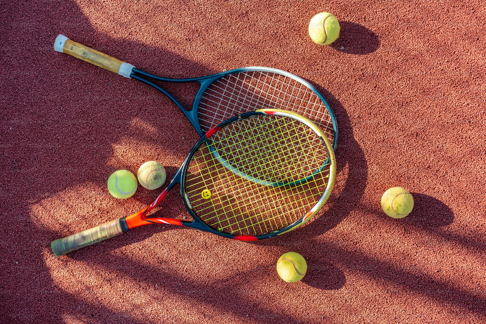 a tennis racket and tennis balls on a tennis court