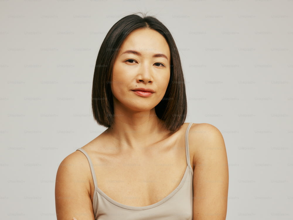a woman in a tank top posing for a picture