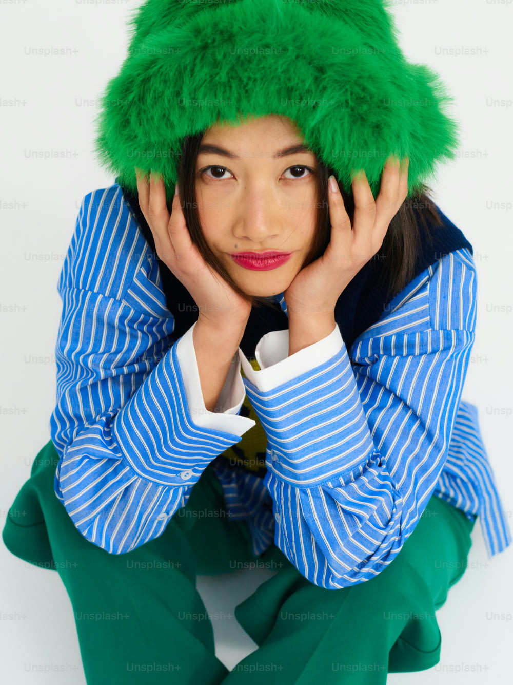a woman with a green hat on her head