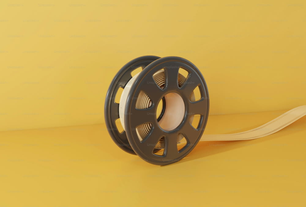 a reel with a spool of thread on a yellow background