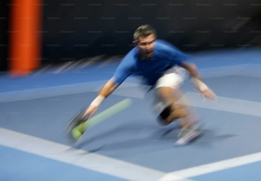 a blurry photo of a man playing tennis