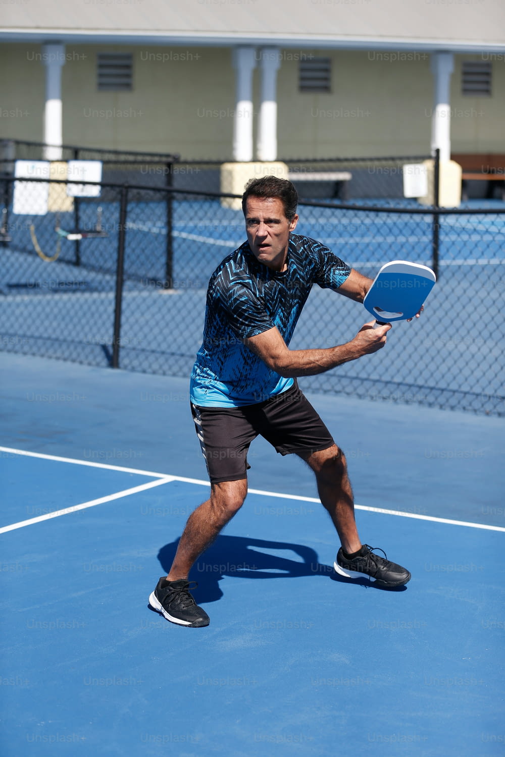 a man holding a tennis racquet on a tennis court