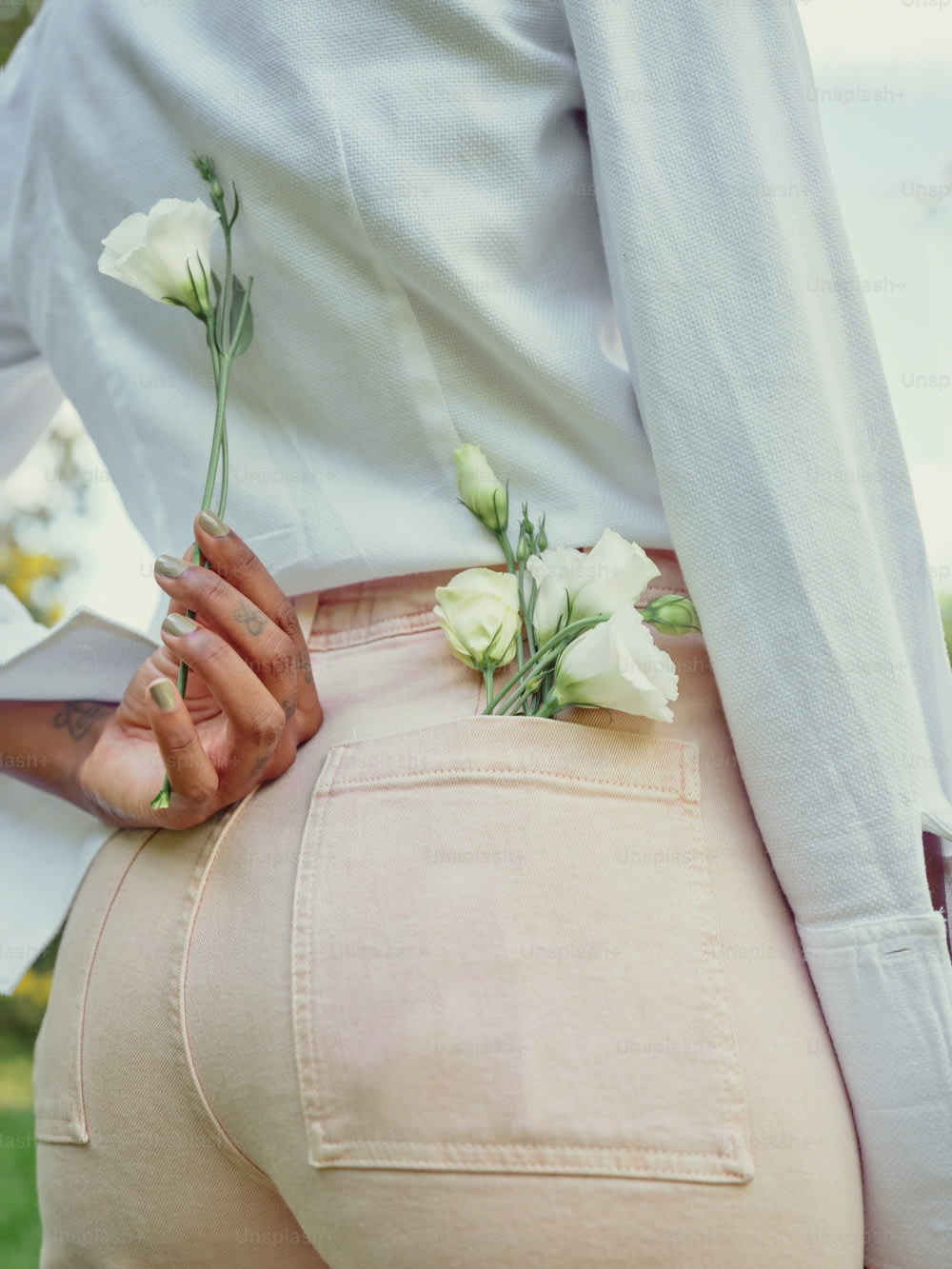 a woman wearing a white shirt and pink pants