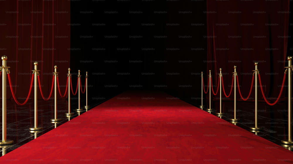 a red carpet with gold poles and a red carpet