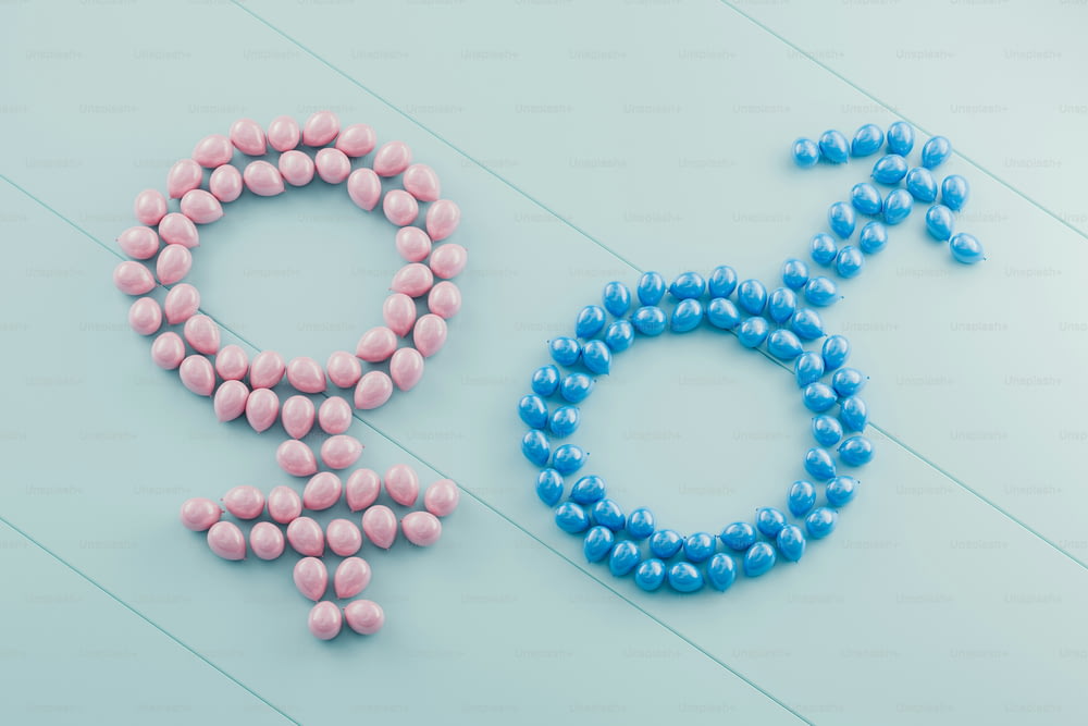 a male and female symbol made out of pink and blue pills
