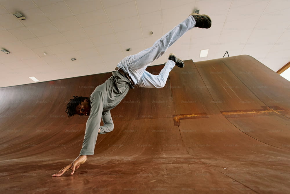 a man doing a trick on a skateboard on a ramp