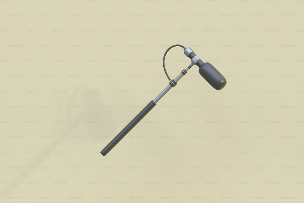 a metal pole with a long handle on a beige background
