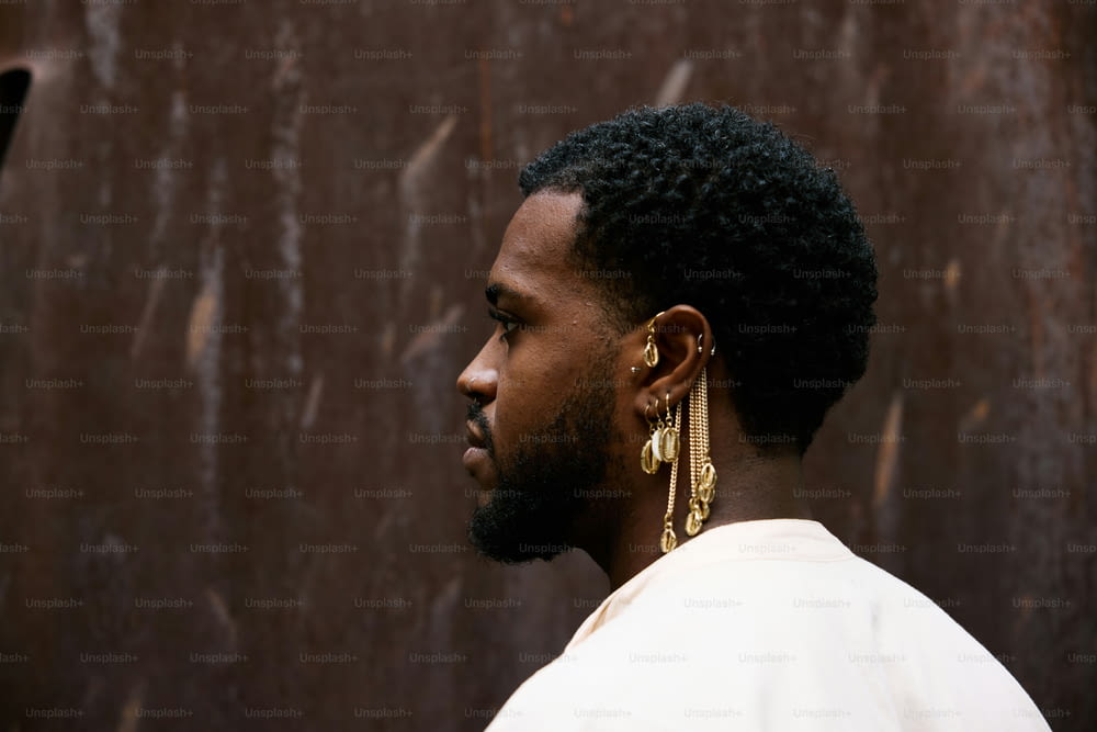 a man with a beard and gold earrings