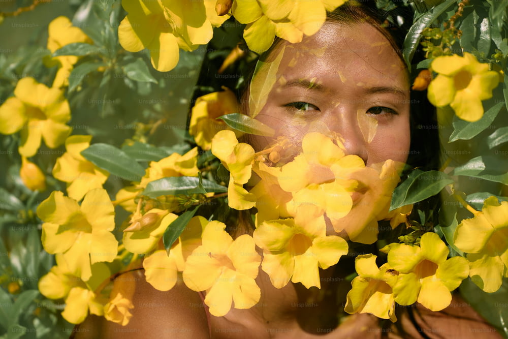 a woman with yellow flowers around her face