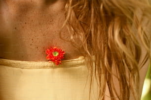 a close up of a person wearing a dress with a flower on it